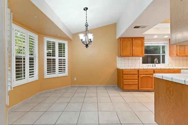 a view of a kitchen with a sink and dishwasher with wooden floor