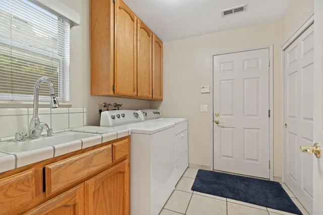 a view of a kitchen with sink and dishwasher with wooden floor