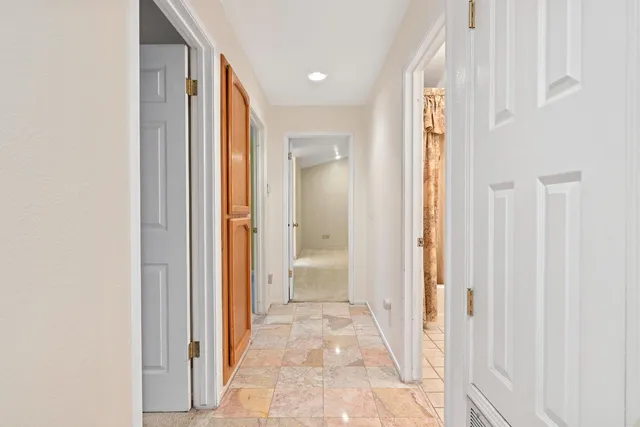 a view of a bathroom from a hallway
