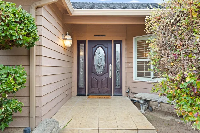 a bench and a potted plant sitting in front of a door
