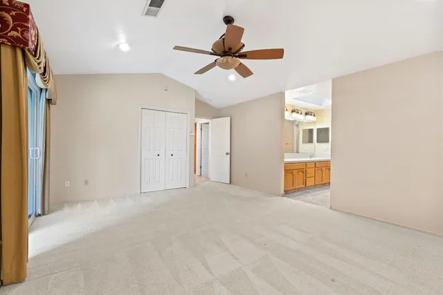 a view of empty room with ceiling fan