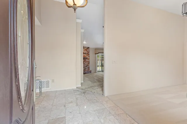 a view of an empty room and fire place