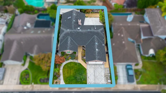 an aerial view of a house with a swimming pool