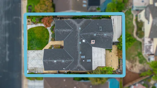 an aerial view of a house with a yard