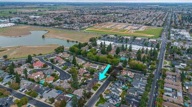 an aerial view of residential houses with outdoor space and river