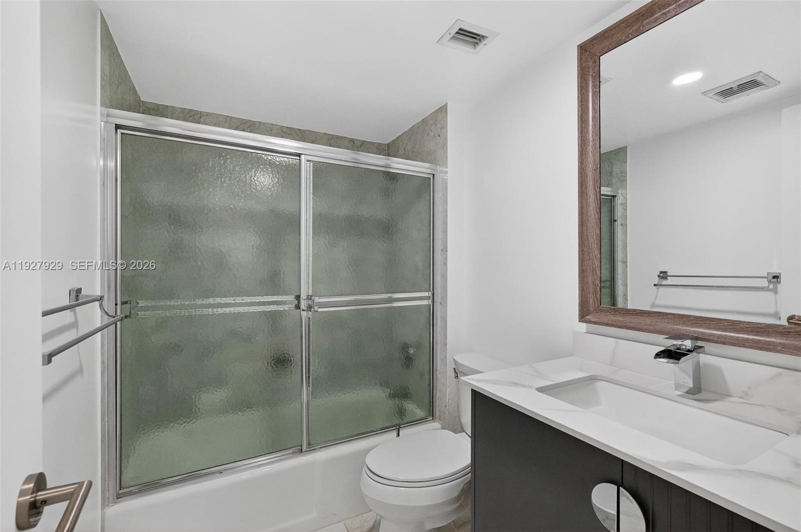 600 Grapetree Drive, Unit 8FS Key Biscayne, FL 33149 - Photo 20 of 54 a bathroom with a shower sink vanity mirror and toilet