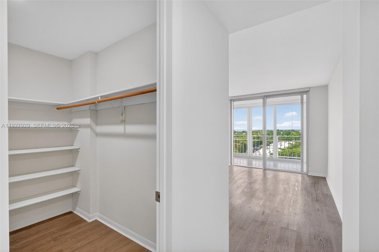 600 Grapetree Drive, Unit 8FS Key Biscayne, FL 33149 - Photo 21 of 54 a view of an empty room with wooden floor and a window
