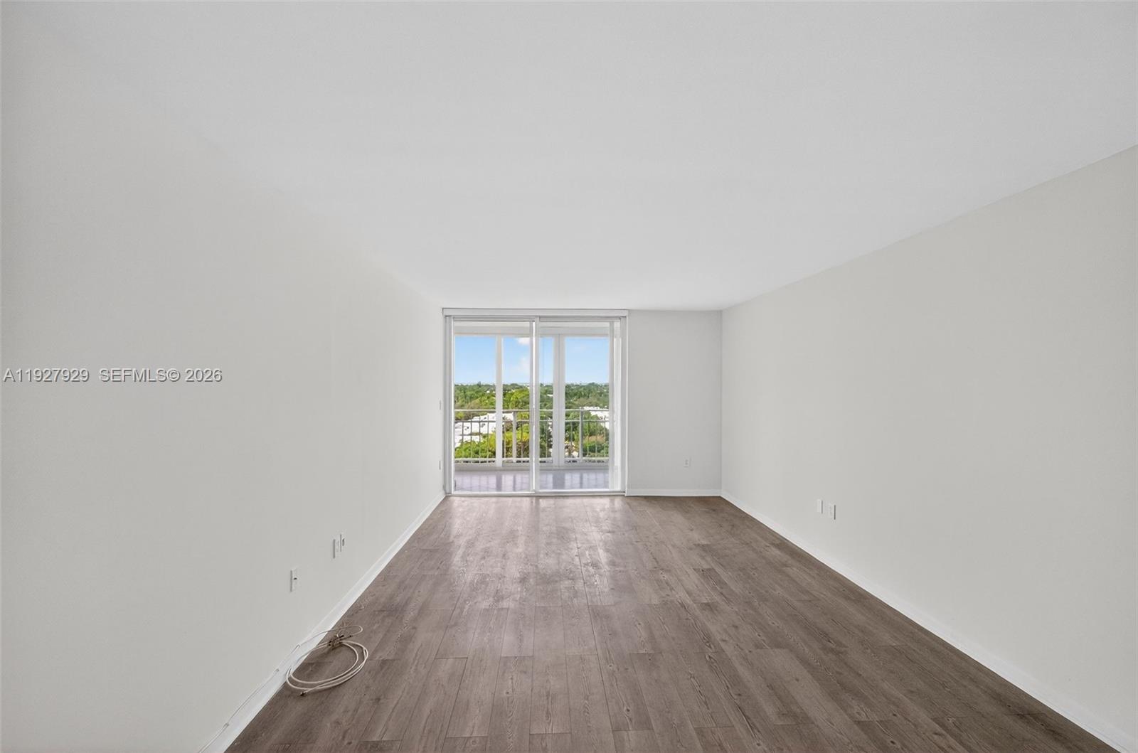 600 Grapetree Drive, Unit 8FS Key Biscayne, FL 33149 - Photo 29 of 54 a view of an empty room with wooden floor and a window