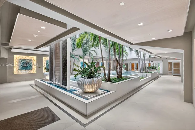 a view of living room with furniture and potted plants