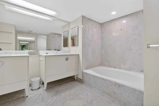 a bathroom with a double vanity sink and mirror