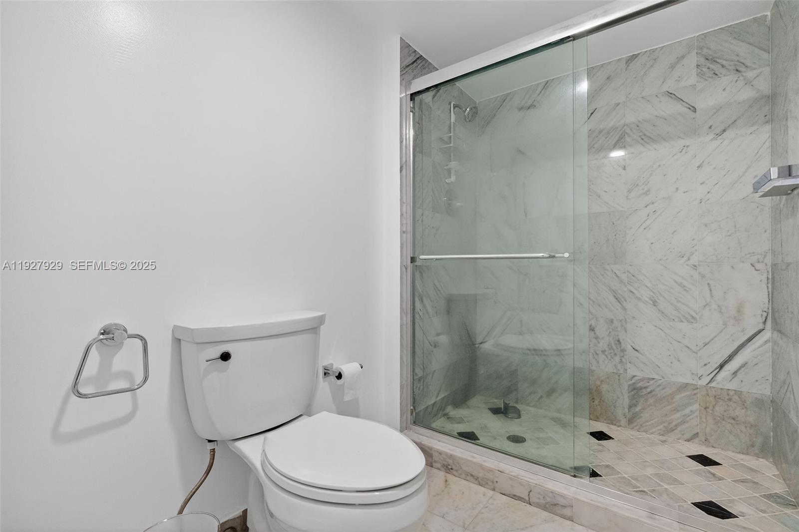 600 Grapetree Drive, Unit 8FS Key Biscayne, FL 33149 - Photo 35 of 54 a bathroom with a shower a toilet and a sink