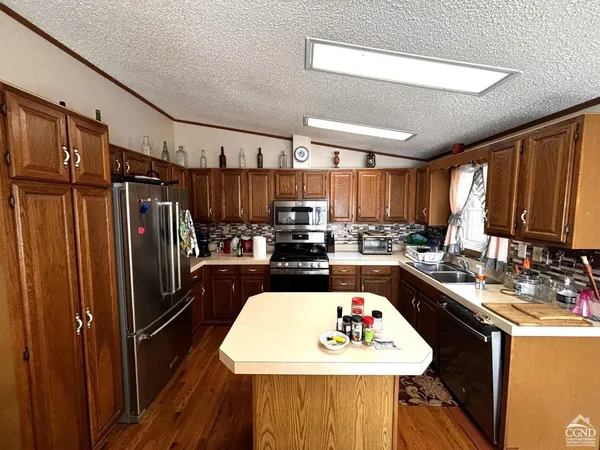 a kitchen with a stove a refrigerator and a stove top oven