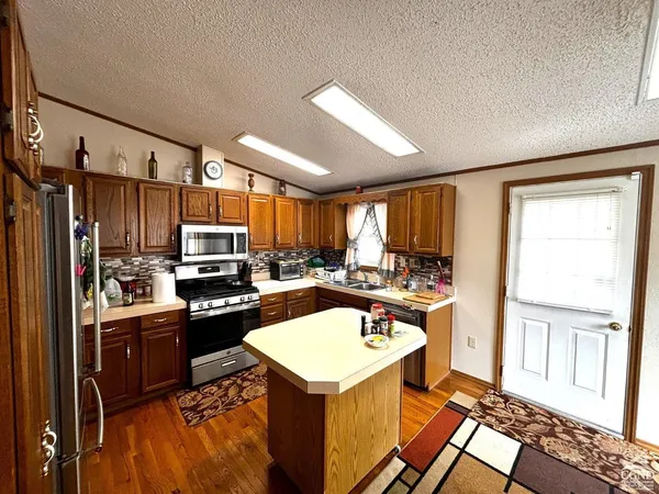 a kitchen with refrigerator and sink