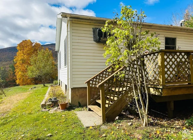a view of a wooden fence with flower garden