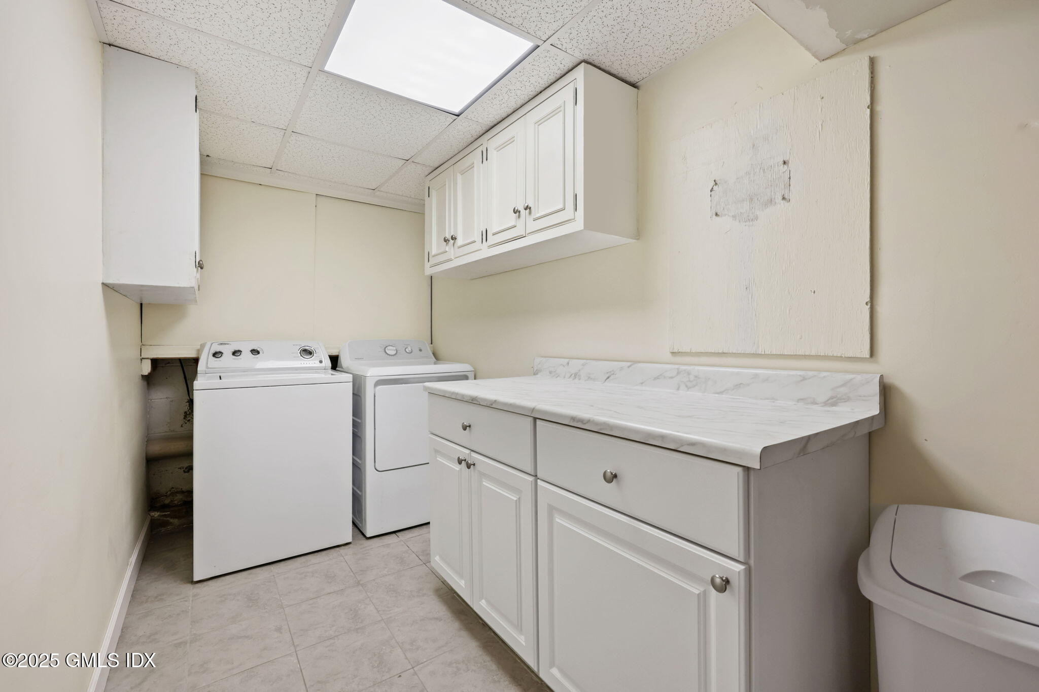 14 Harold Avenue, Unit 4 Greenwich, CT 06830 - Photo 19 of 23 a utility room with cabinets washer and dryer