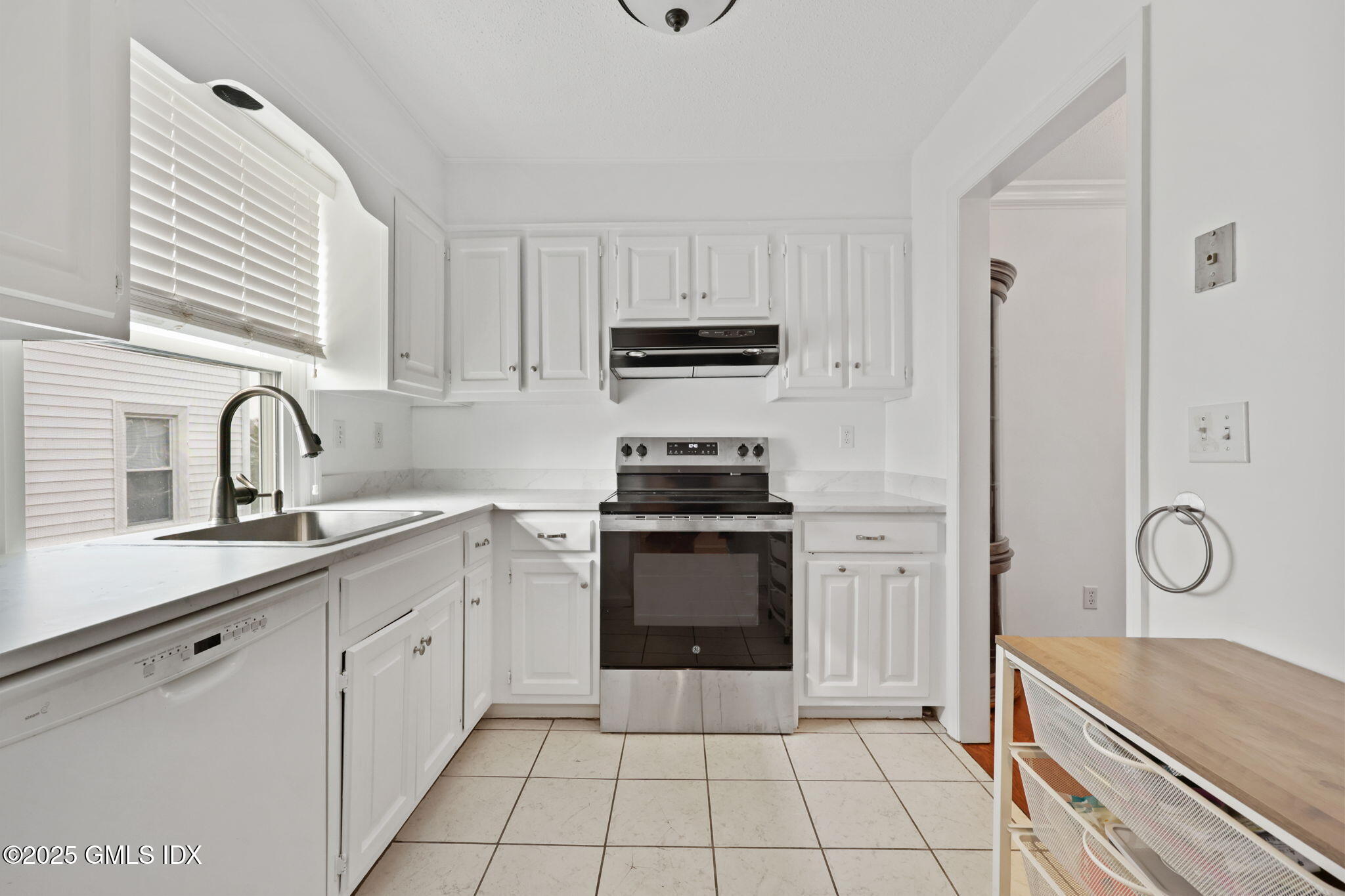 14 Harold Avenue, Unit 4 Greenwich, CT 06830 - Photo 4 of 23 a kitchen with white cabinets a sink and appliances