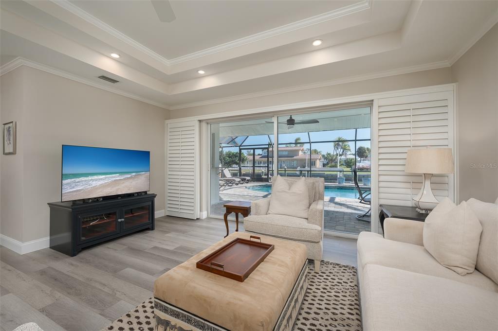 548 Gunwale Lane Longboat Key, FL 34228 - Photo 16 of 62 a living room with furniture and a flat screen tv