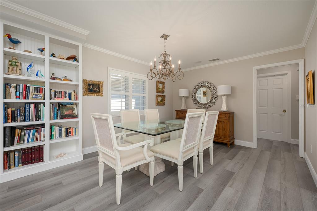 548 Gunwale Lane Longboat Key, FL 34228 - Photo 21 of 62 a view of a dining room with furniture a book and wooden floor