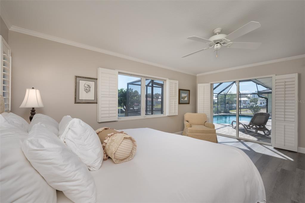 548 Gunwale Lane Longboat Key, FL 34228 - Photo 26 of 62 a bedroom with a large bed and a large window with outer view