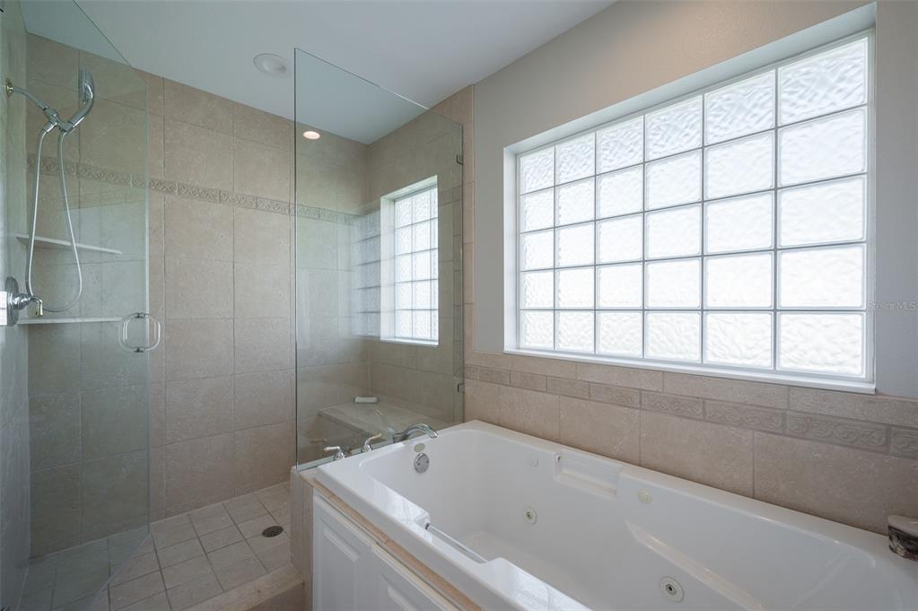 548 Gunwale Lane Longboat Key, FL 34228 - Photo 29 of 62 a bathroom with a bathtub and window