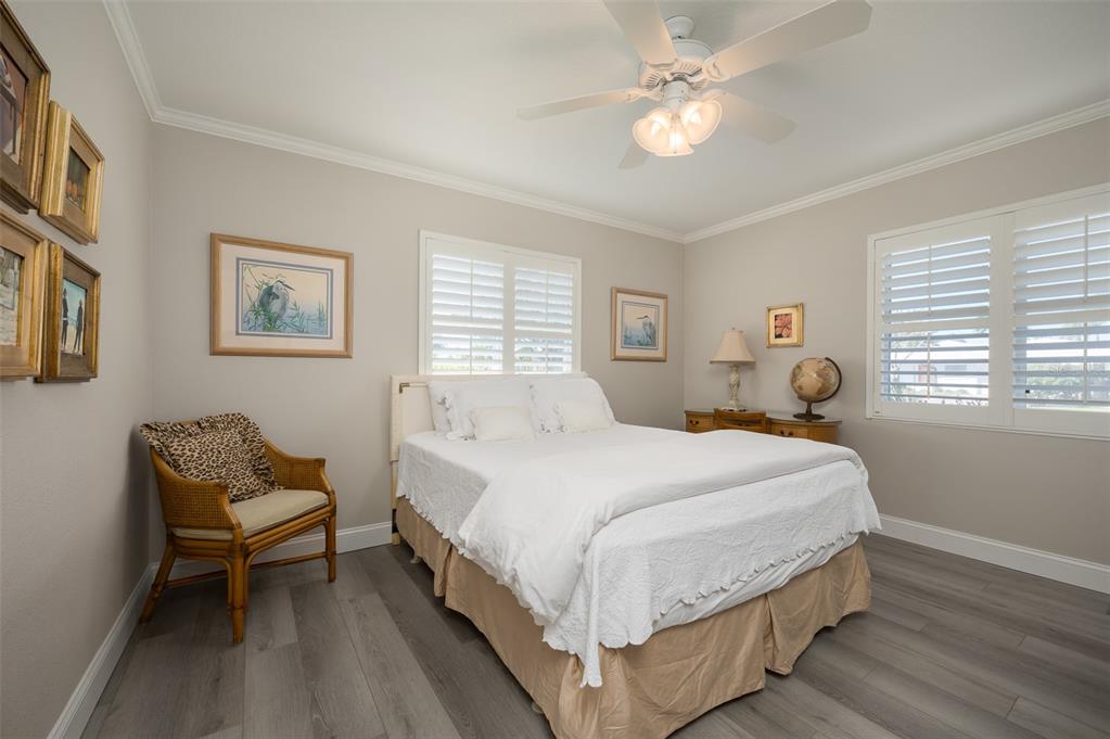 548 Gunwale Lane Longboat Key, FL 34228 - Photo 31 of 62 a bedroom with a bed and a chandelier