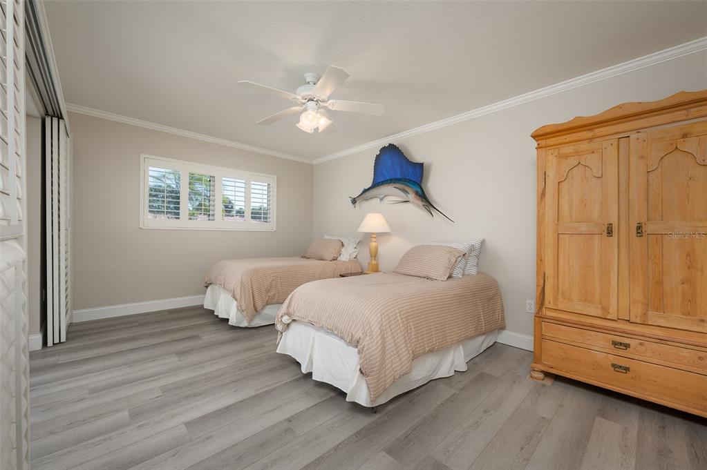 548 Gunwale Lane Longboat Key, FL 34228 - Photo 32 of 62 a bedroom with bed and wooden floor