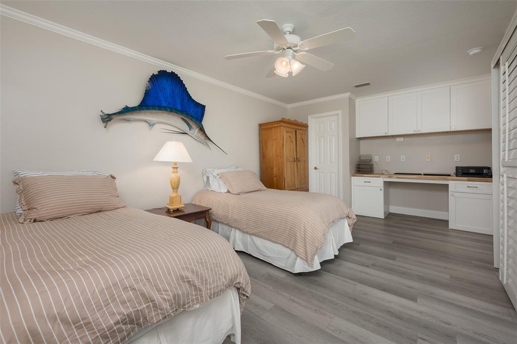 548 Gunwale Lane Longboat Key, FL 34228 - Photo 33 of 62 a bedroom with two beds and a chandelier