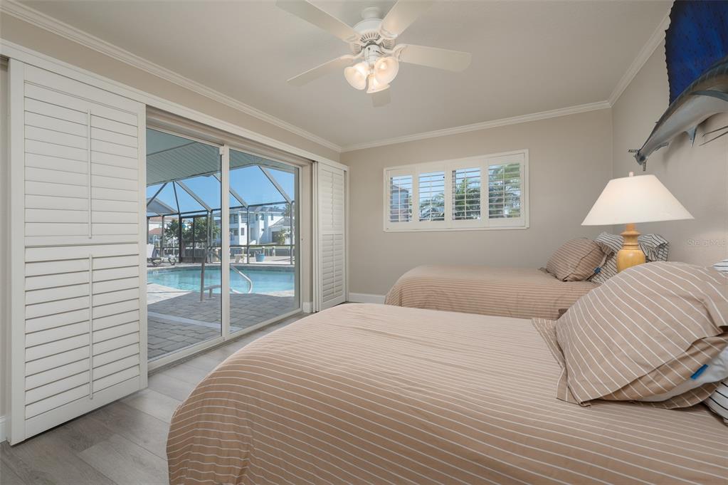 548 Gunwale Lane Longboat Key, FL 34228 - Photo 34 of 62 a bedroom with a bed and a chandelier
