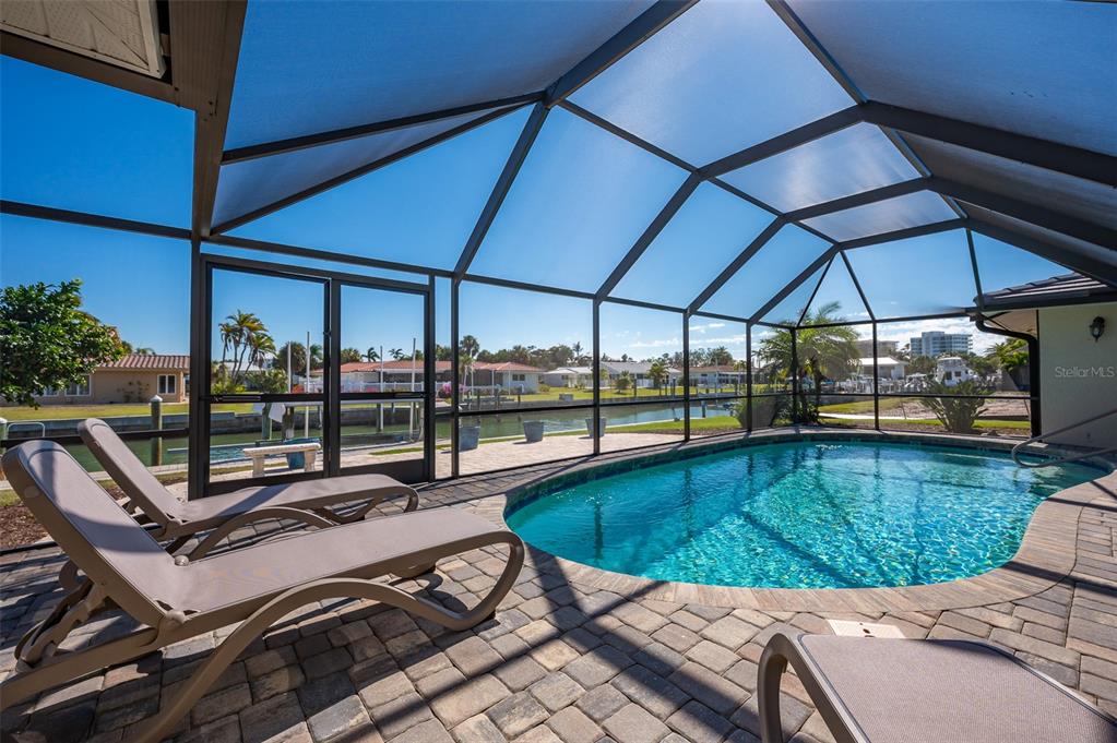 548 Gunwale Lane Longboat Key, FL 34228 - Photo 39 of 62 a view of a swimming pool with a patio
