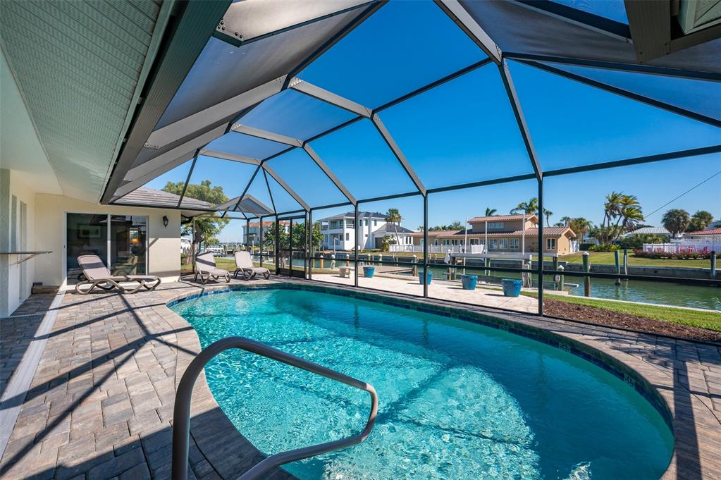 548 Gunwale Lane Longboat Key, FL 34228 - Photo 41 of 62 a view of a swimming pool with a patio