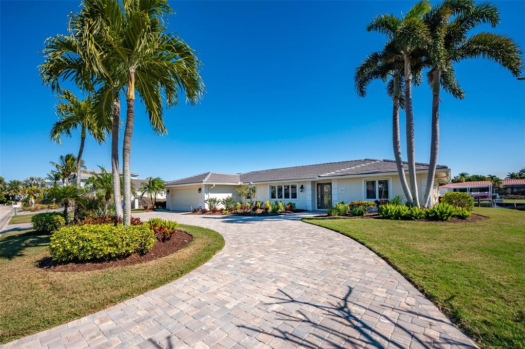 548 Gunwale Lane Longboat Key, FL 34228 - Photo 10 of 62 a front view of a house with garden and trees