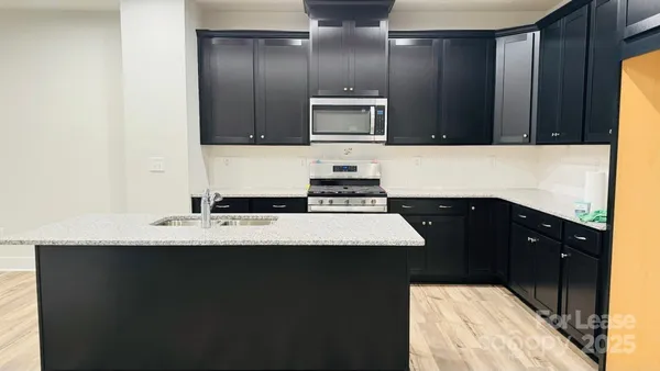 a kitchen with a sink and a refrigerator