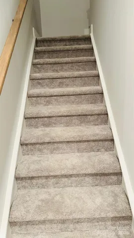 an empty room with closet and entryway