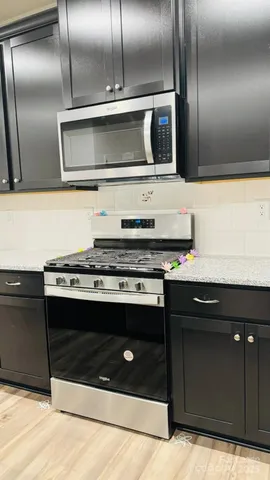 a view of granite countertop stainless steel appliances wooden cabinets