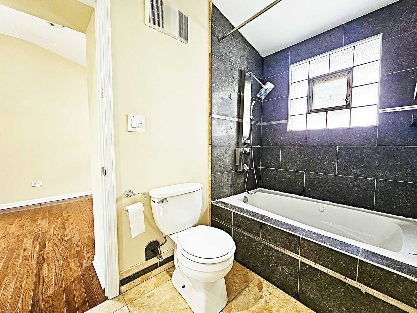 1546 State Line Road Calumet City, IL 60409 - Photo 11 of 16 a bathroom with a toilet a sink and a shower