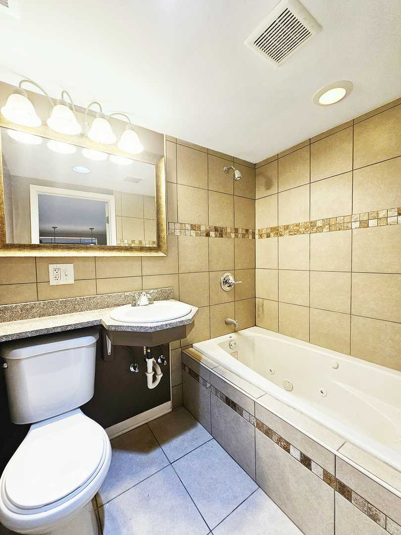 1546 State Line Road Calumet City, IL 60409 - Photo 14 of 16 a bathroom with a granite countertop toilet sink and mirror