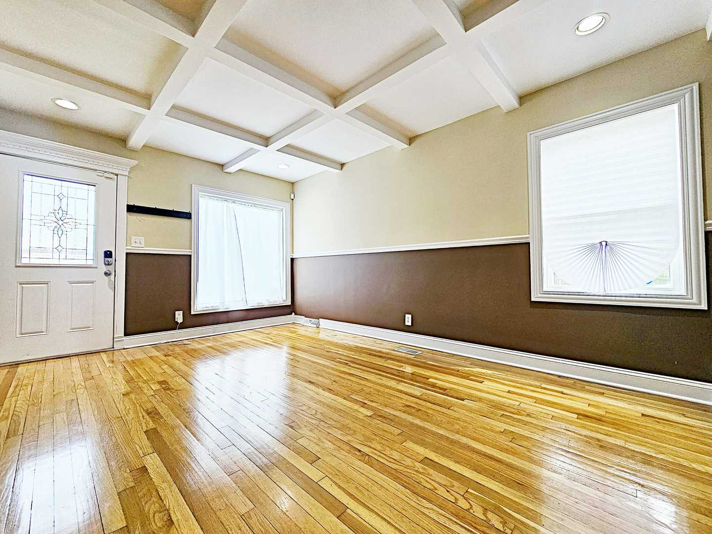 1546 State Line Road Calumet City, IL 60409 - Photo 3 of 16 an empty room with wooden floor and windows