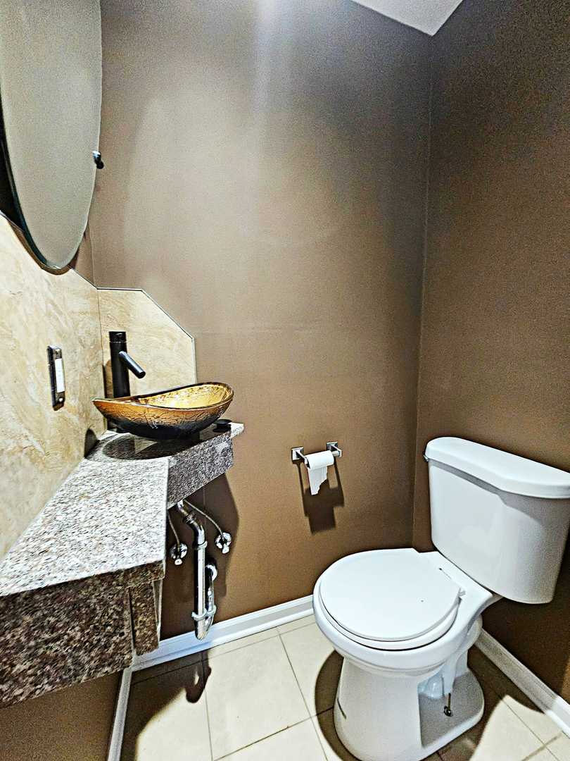 1546 State Line Road Calumet City, IL 60409 - Photo 6 of 16 a white toilet sitting next to a bathroom sink