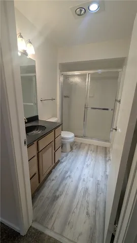 a view of a room with wooden floor and white walls
