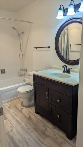 a bathroom with a sink vanity mirror and toilet