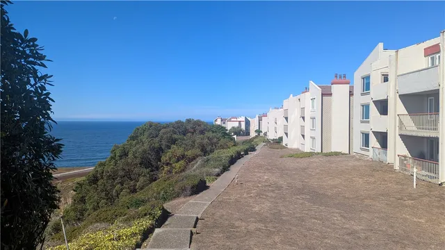 a view of a street with an ocean
