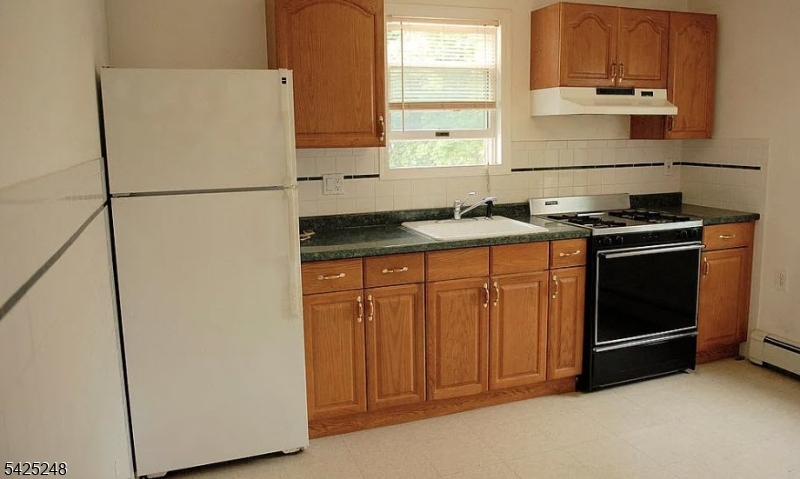 540 Joyce Street Orange, NJ 07050 - Photo 4 of 9 a kitchen with stainless steel appliances granite countertop a stove a refrigerator and a sink