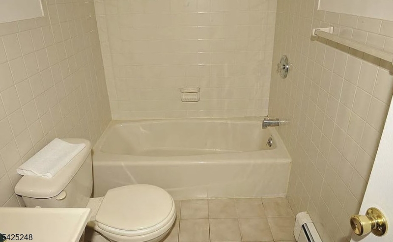 540 Joyce Street Orange, NJ 07050 - Photo 5 of 9 a bathroom with a toilet and a shower