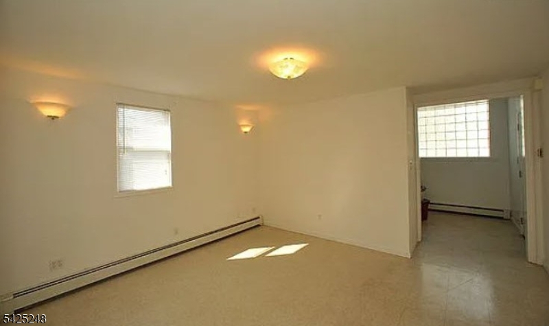 540 Joyce Street Orange, NJ 07050 - Photo 7 of 9 an empty room with a empty space and windows