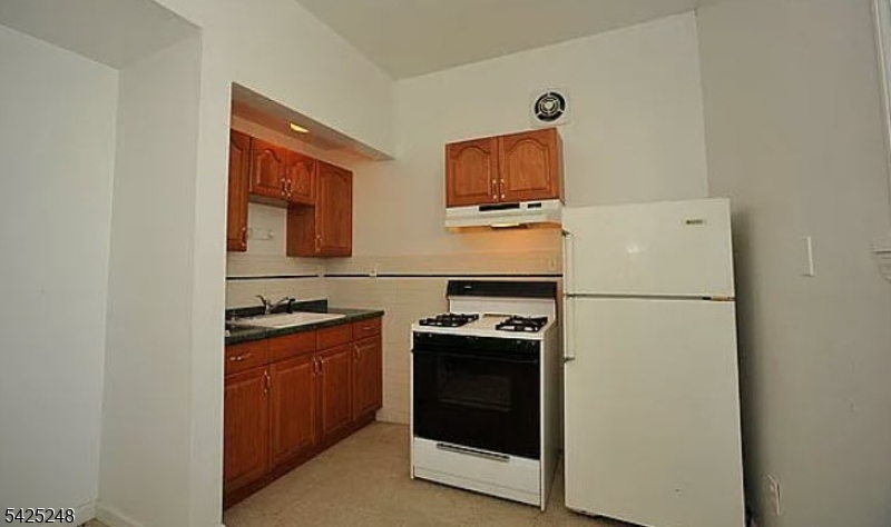 540 Joyce Street Orange, NJ 07050 - Photo 8 of 9 a kitchen with a refrigerator stove and microwave