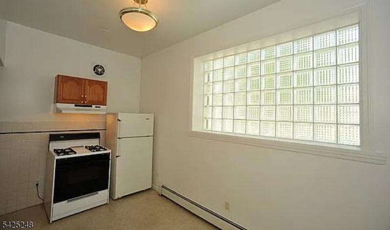 540 Joyce Street Orange, NJ 07050 - Photo 9 of 9 a kitchen with a refrigerator and a stove