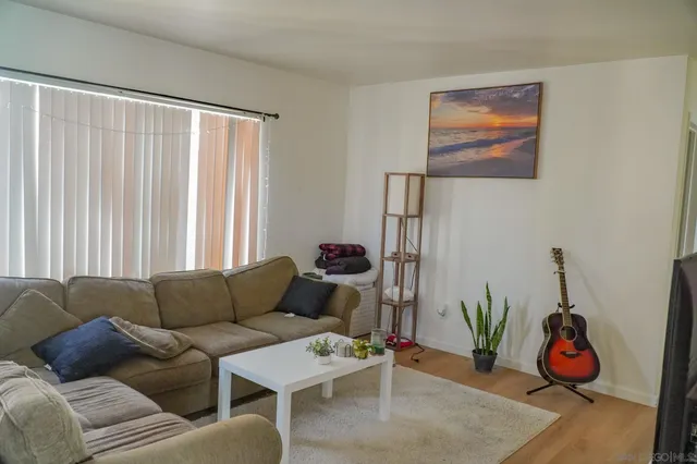 a kitchen with stainless steel appliances granite countertop a stove a sink dishwasher and a refrigerator with wooden floor