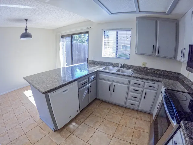 a kitchen with sink cabinets and window