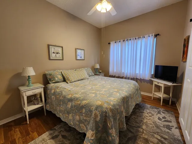 a bathroom with a granite countertop sink a mirror and a shower