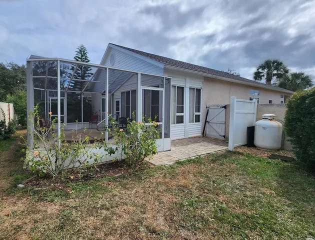 a view of a swimming pool with a patio and a yard